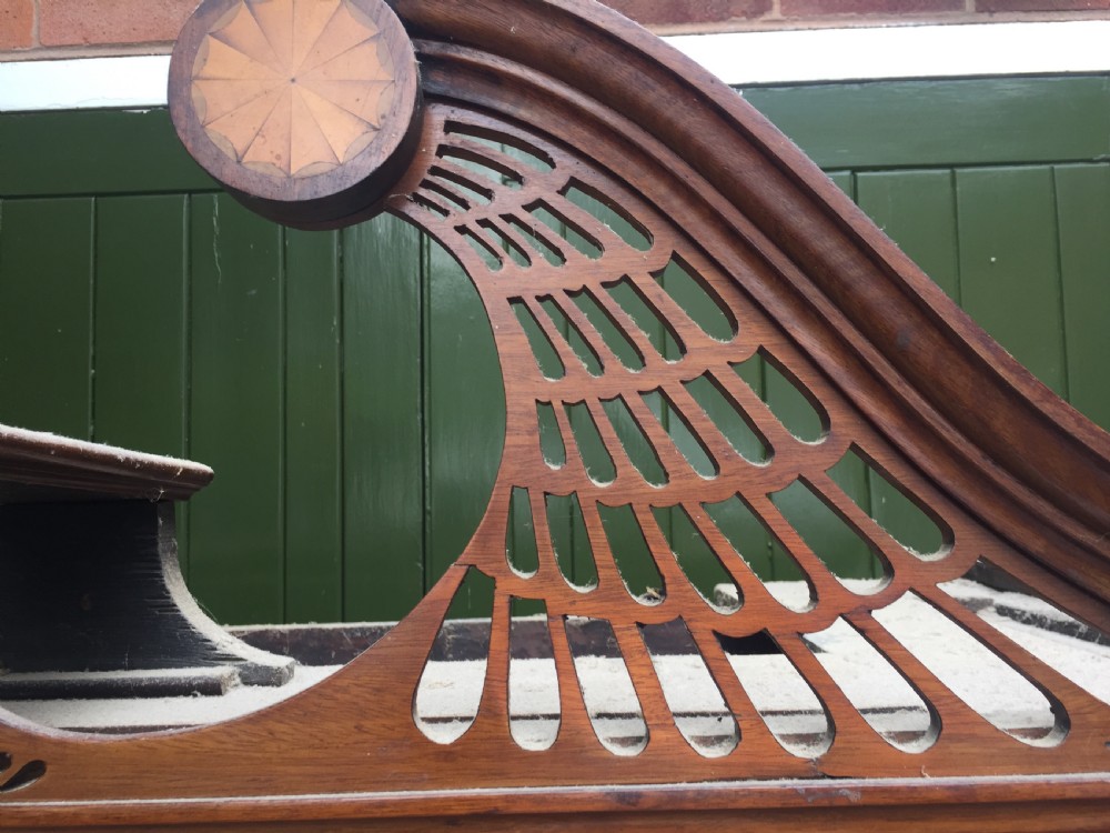 A late 18th-century George III mahogany and satinwood linen press with a swan-neck pediment, oval inlaid cupboard doors, and four lower drawers. View V