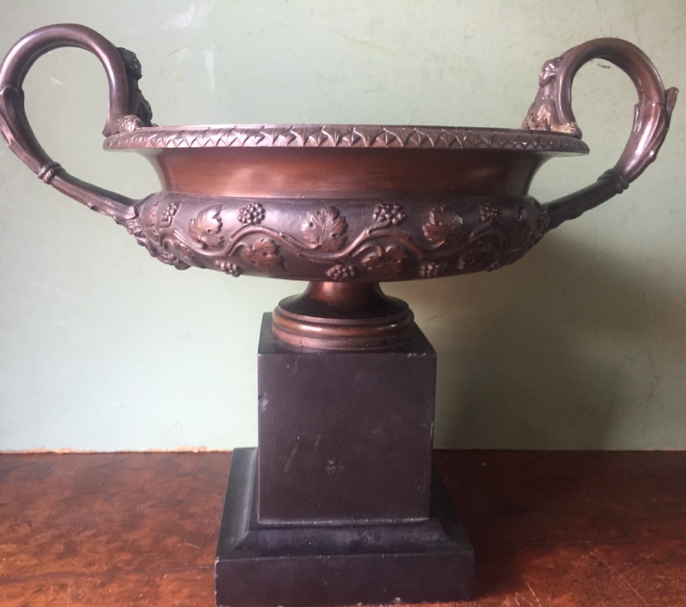 An early nineteenth-century Italian bronze twin-handled tazza featuring relief-carved vine leaves and grapes mounted on a square black base. View II