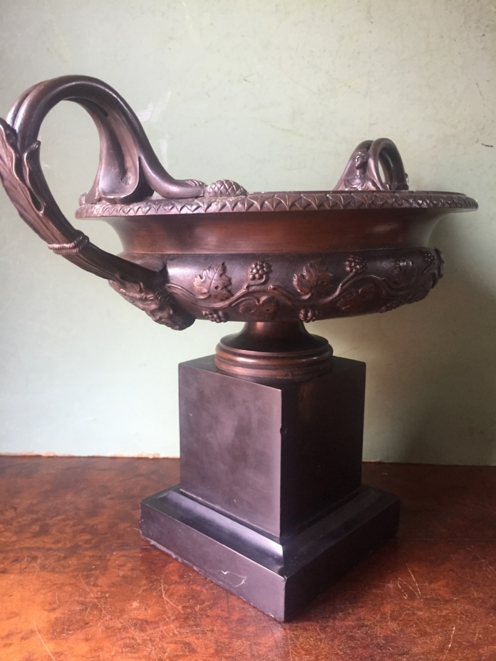 An early nineteenth-century Italian bronze twin-handled tazza featuring relief-carved vine leaves and grapes mounted on a square black base. View III