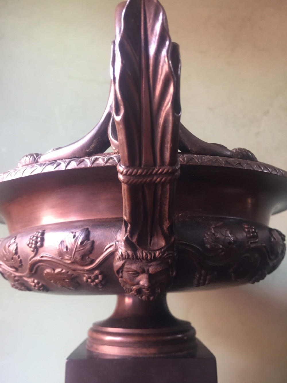 An early nineteenth-century Italian bronze twin-handled tazza featuring relief-carved vine leaves and grapes mounted on a square black base. View IV