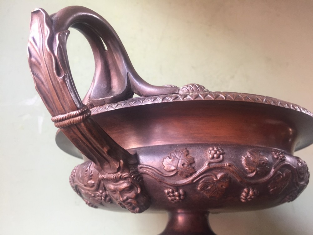 An early nineteenth-century Italian bronze twin-handled tazza featuring relief-carved vine leaves and grapes mounted on a square black base. View XIII