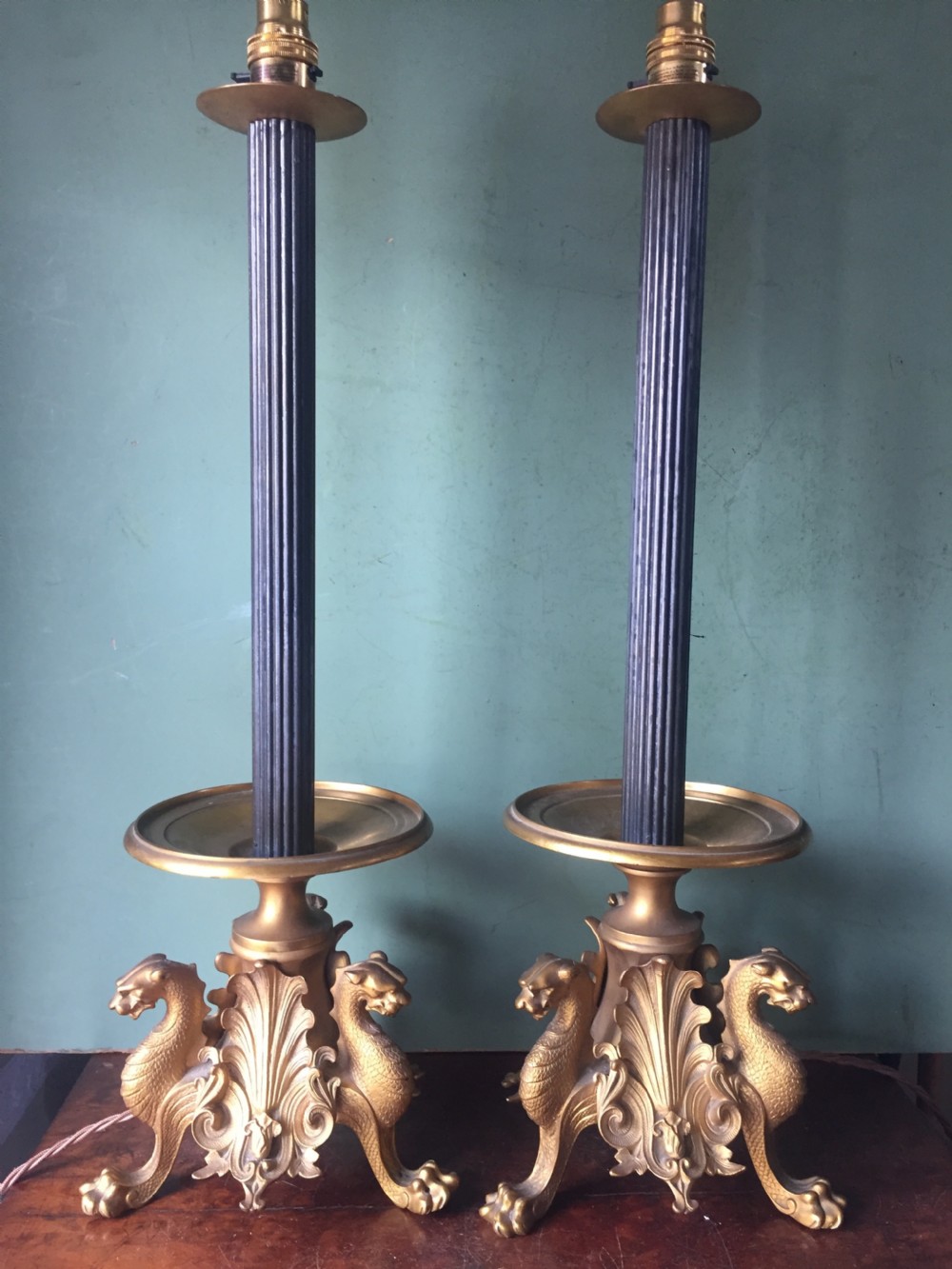 Pair of late C19th French gilt and patinated bronze lamps raised on tri-form griffin supports.