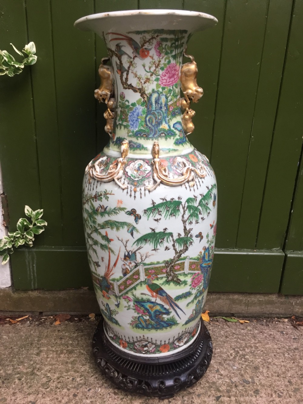 Large scale C19th Chinese Cantonese porcelain enamel decorated vase on hardwood stand in repaired 'country house' condition . View X