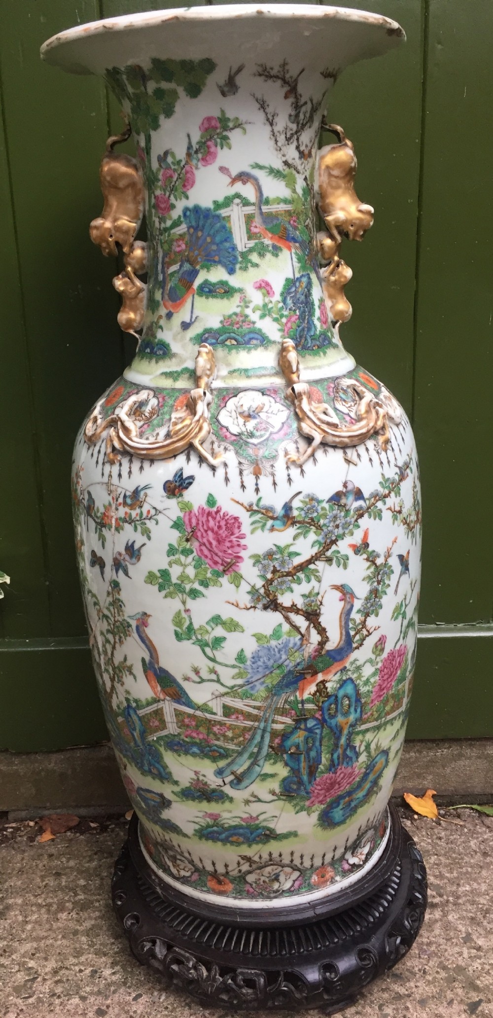 Large scale C19th Chinese Cantonese porcelain enamel decorated vase on hardwood stand in repaired 'country house' condition .