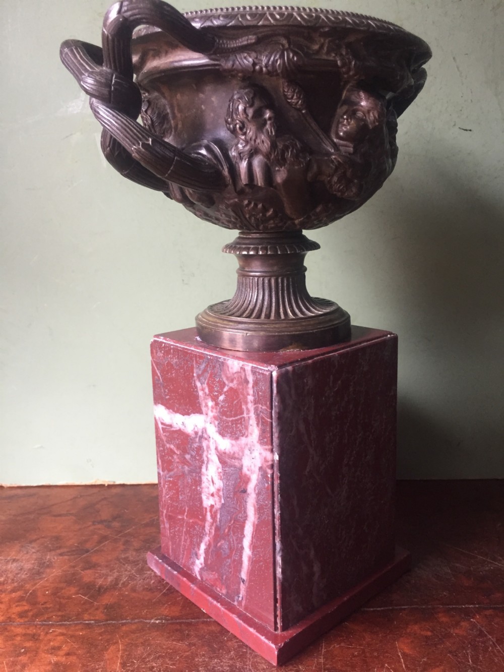 A nineteenth-century dark bronze reduction of the Warwick Vase with Bacchanalian masks and vine handles, mounted on a red marble square base. View IV