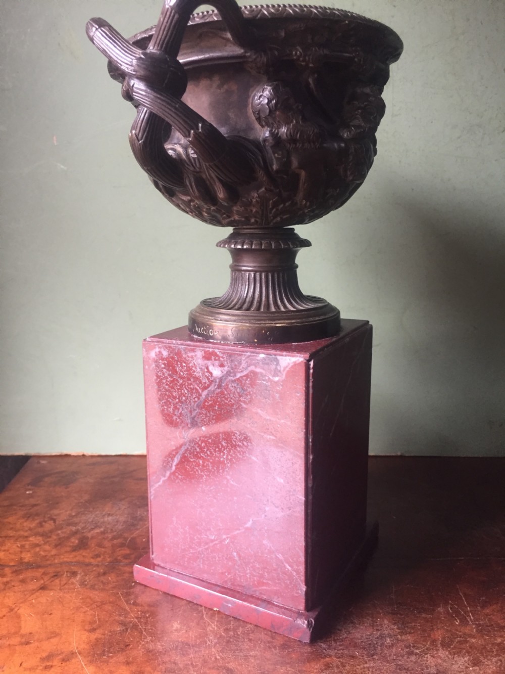 A nineteenth-century dark bronze reduction of the Warwick Vase with Bacchanalian masks and vine handles, mounted on a red marble square base. View VIII