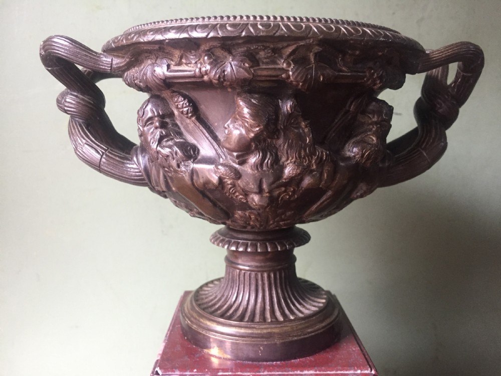 A nineteenth-century dark bronze reduction of the Warwick Vase with Bacchanalian masks and vine handles, mounted on a red marble square base. View X