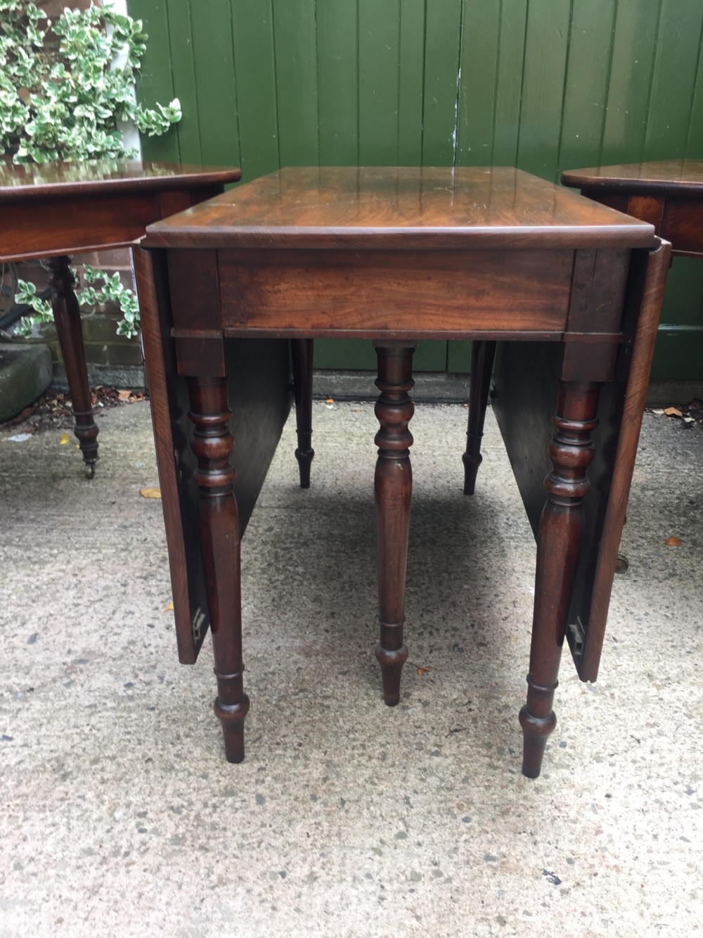 A Regency mahogany extending dining table with turned legs and brass castors. View XIII