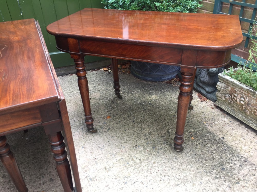 A Regency mahogany extending dining table with turned legs and brass castors. View XIV