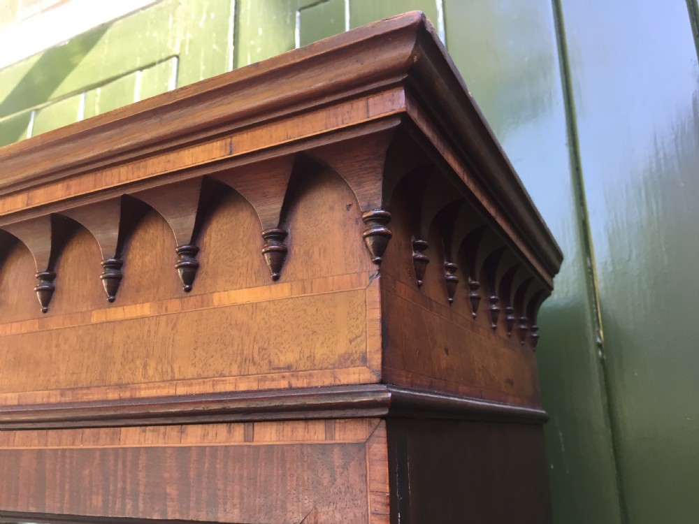 A late Victorian mahogany glazed cabinet featuring upper astragal doors with gothic tracery above two drawers and oval inlaid cupboard doors. View III