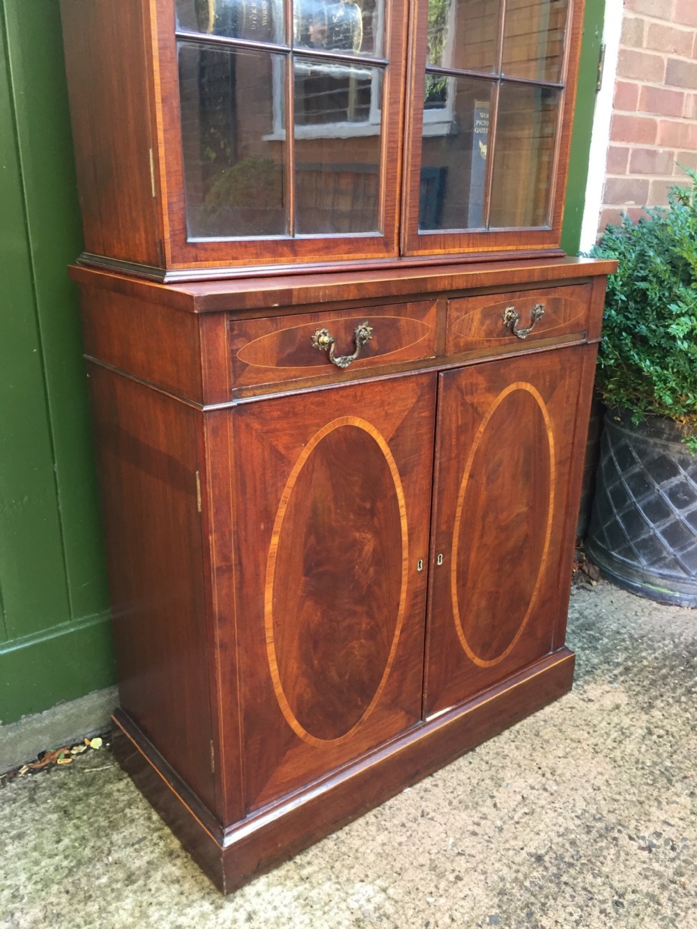 A late Victorian mahogany glazed cabinet featuring upper astragal doors with gothic tracery above two drawers and oval inlaid cupboard doors. View VIII