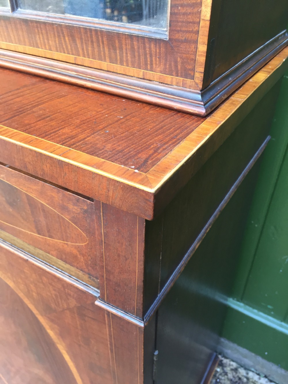 A late Victorian mahogany glazed cabinet featuring upper astragal doors with gothic tracery above two drawers and oval inlaid cupboard doors. View XI