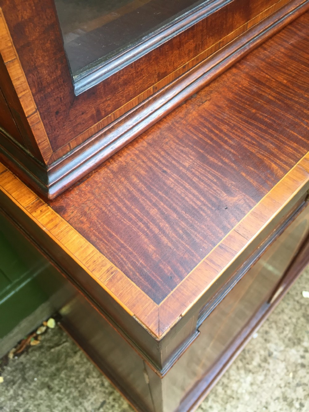 A late Victorian mahogany glazed cabinet featuring upper astragal doors with gothic tracery above two drawers and oval inlaid cupboard doors. View XXIII