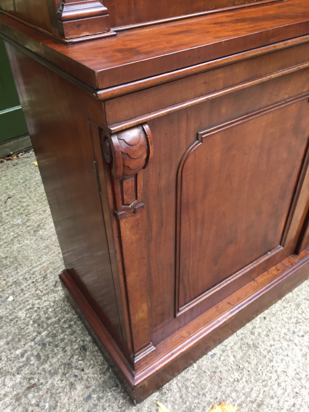 A mid nineteenth-century mahogany library bookcase featuring twin glazed doors over a two-door solid timber cupboard base. View XIV