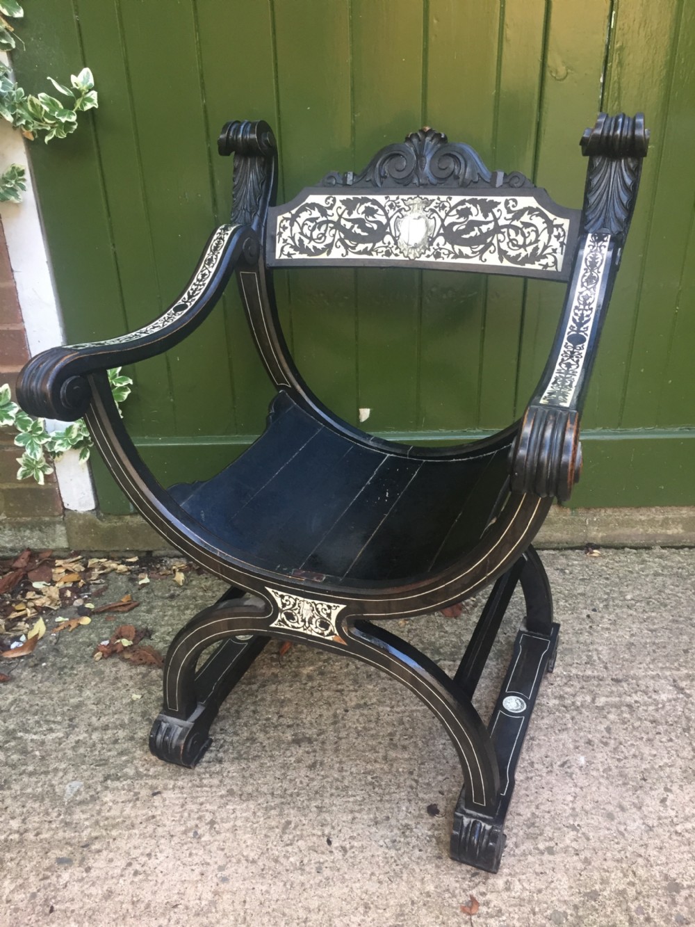C19th Italian ebonised and ivory inlaid 'Savonarola' type armchair of Renaissance style.