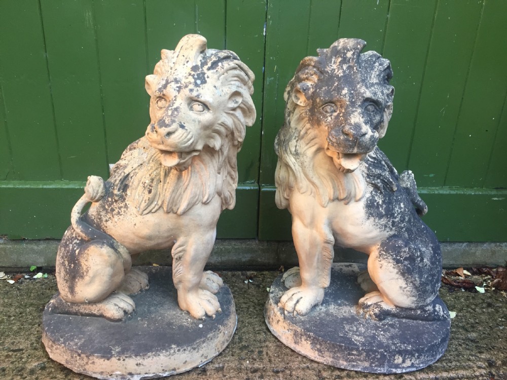 Fine and decorative pair of C19th weathered terracotta sitting lions in the C18th anthropomorphic taste.