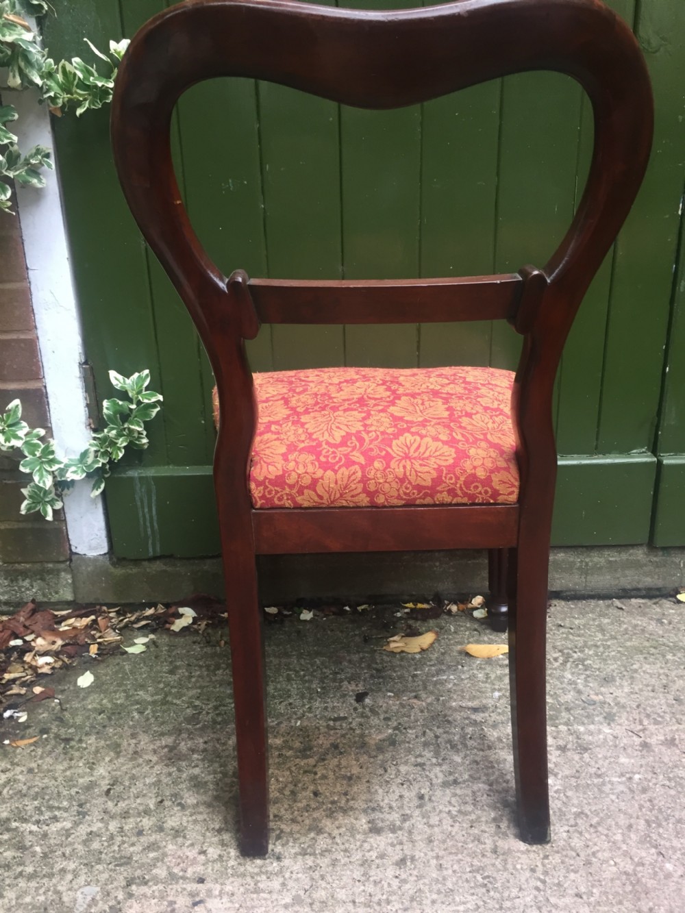 A set of six early nineteenth-century George IV mahogany dining chairs featuring carved balloon back frames, reeded legs, and red pattern upholstered seats. View XIV