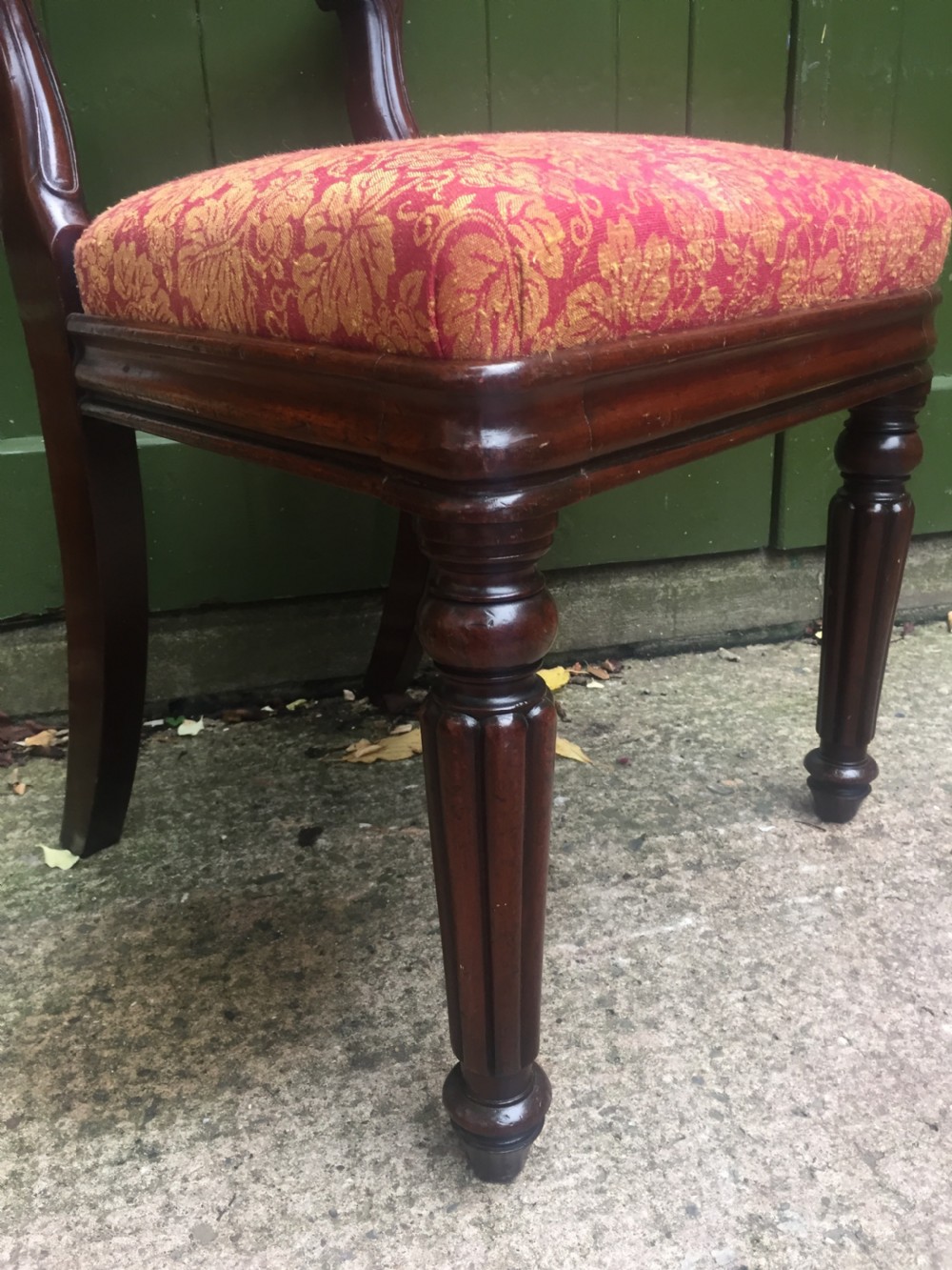 A set of six early nineteenth-century George IV mahogany dining chairs featuring carved balloon back frames, reeded legs, and red pattern upholstered seats. View XVII