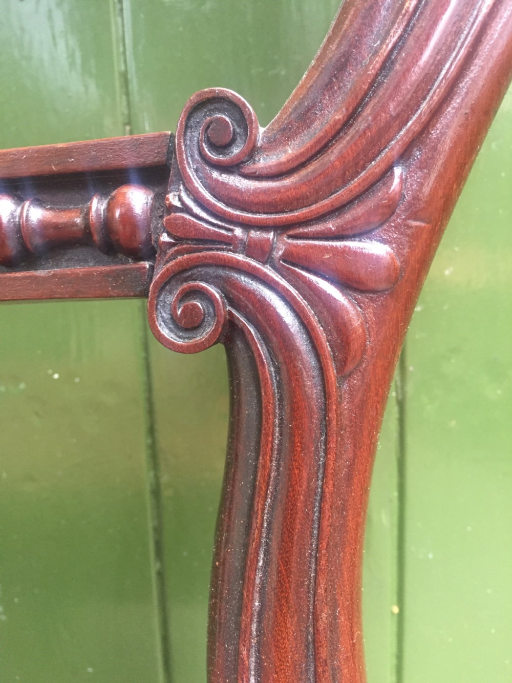 A set of six early nineteenth-century George IV mahogany dining chairs featuring carved balloon back frames, reeded legs, and red pattern upholstered seats. View XVIII