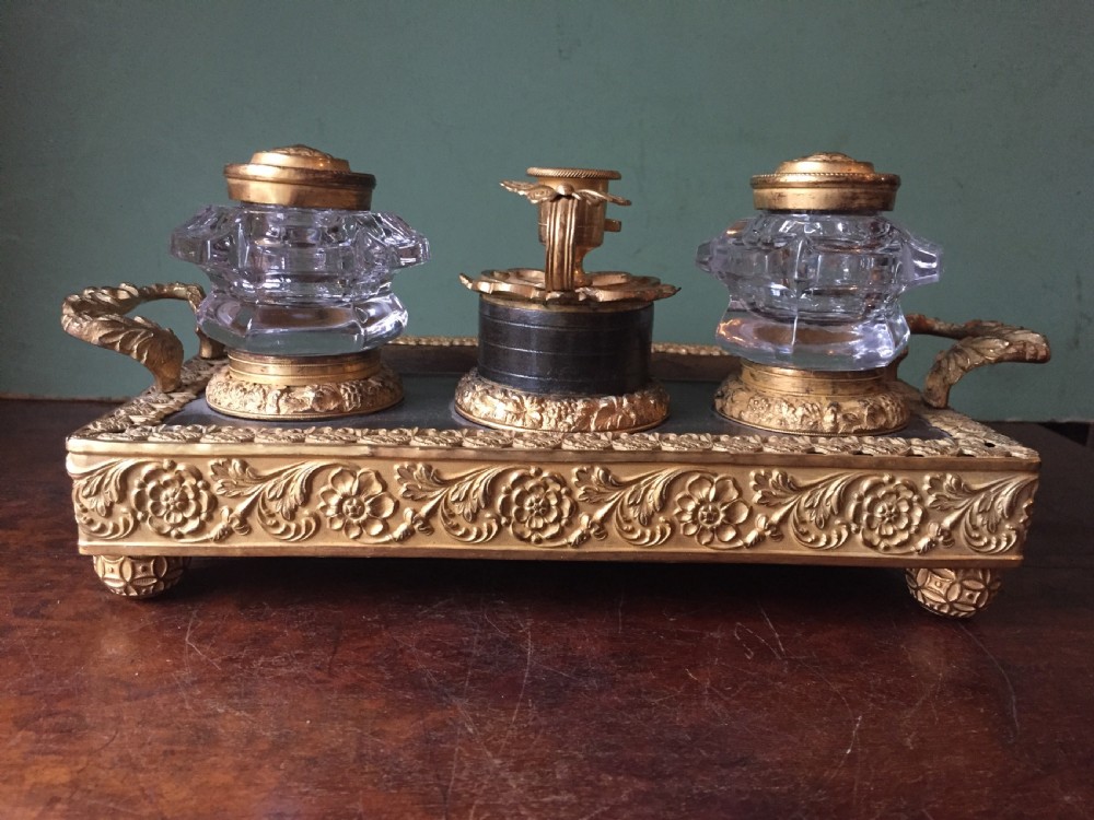 An early nineteenth-century French Empire style ormolu inkstand featuring two cut-crystal inkwells, a central holder, foliate handles, and a decorative gilt bronze tray. View VIII