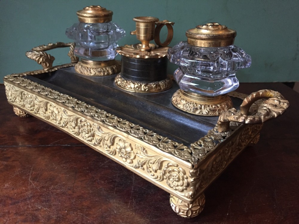 An early nineteenth-century French Empire style ormolu inkstand featuring two cut-crystal inkwells, a central holder, foliate handles, and a decorative gilt bronze tray. View XII