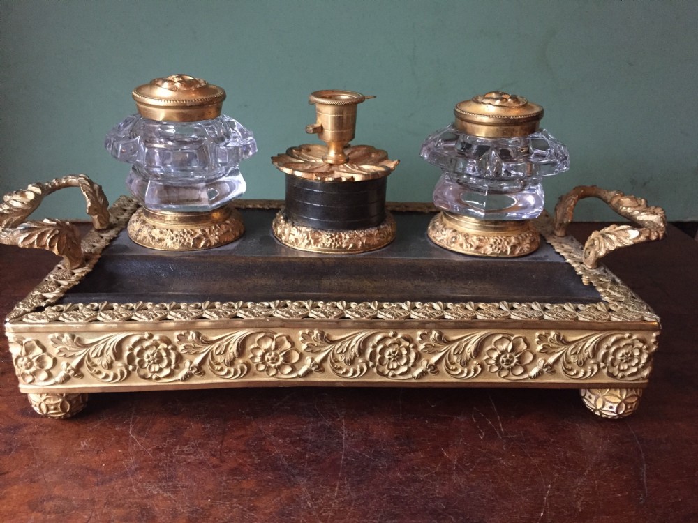 An early nineteenth-century French Empire style ormolu inkstand featuring two cut-crystal inkwells, a central holder, foliate handles, and a decorative gilt bronze tray. View XIII