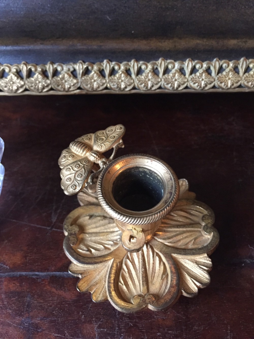 An early nineteenth-century French Empire style ormolu inkstand featuring two cut-crystal inkwells, a central holder, foliate handles, and a decorative gilt bronze tray. View XVIII