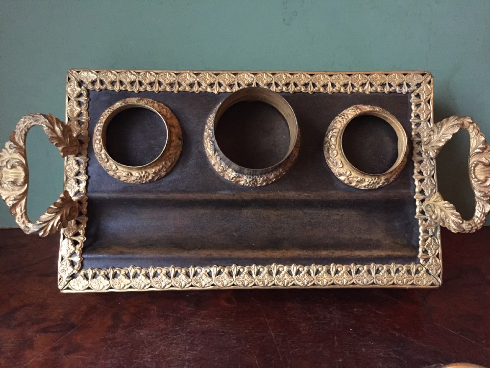 An early nineteenth-century French Empire style ormolu inkstand featuring two cut-crystal inkwells, a central holder, foliate handles, and a decorative gilt bronze tray. View XIX