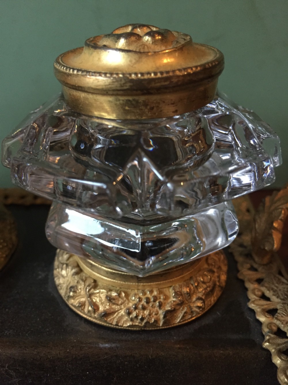An early nineteenth-century French Empire style ormolu inkstand featuring two cut-crystal inkwells, a central holder, foliate handles, and a decorative gilt bronze tray. View XXII