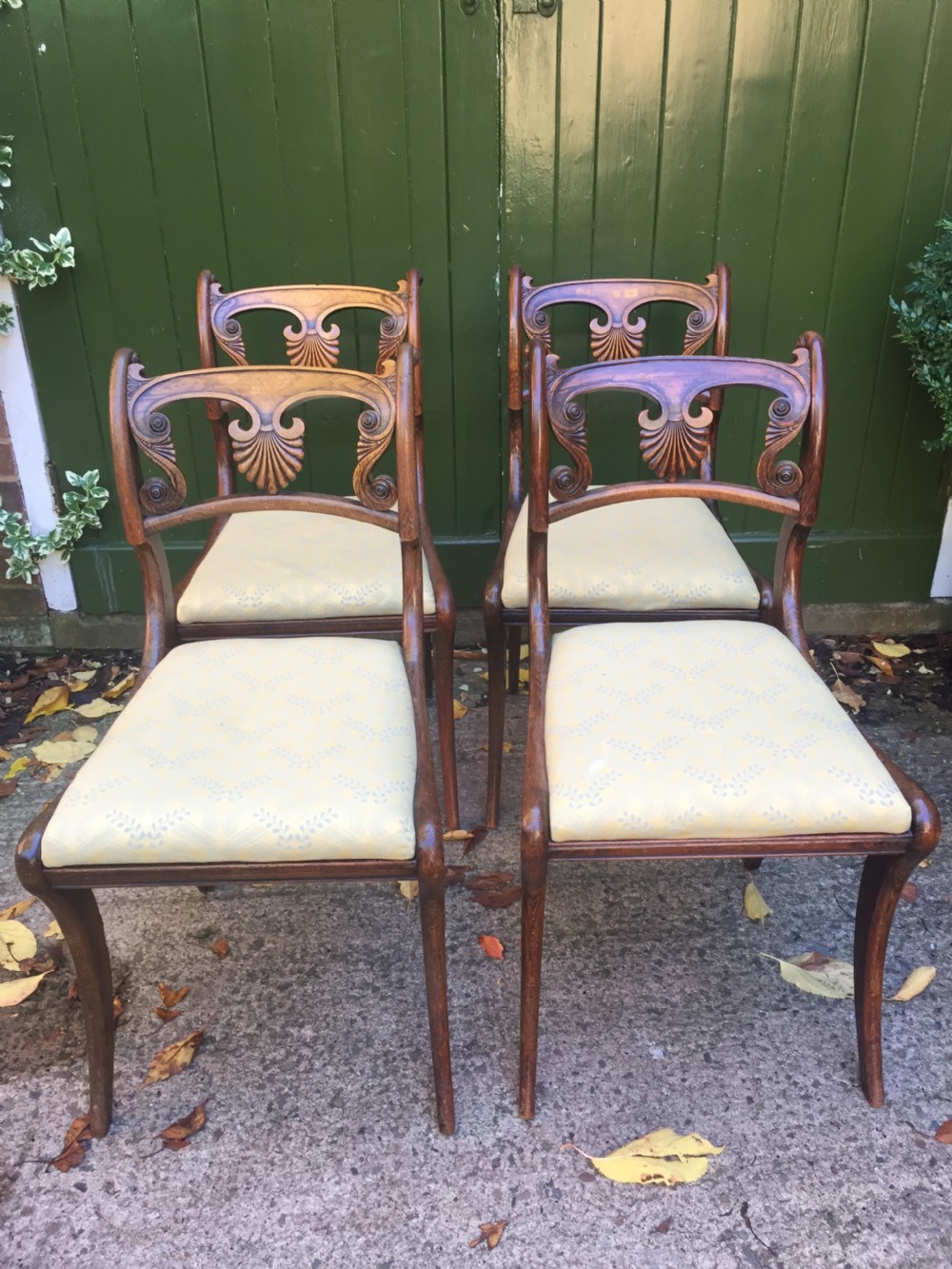 A set of four early nineteenth-century Regency Greek Revival side chairs with carved anthemion backrests and yellow upholstered seats. View III