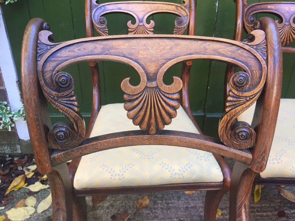 A set of four early nineteenth-century Regency Greek Revival side chairs with carved anthemion backrests and yellow upholstered seats. View IV