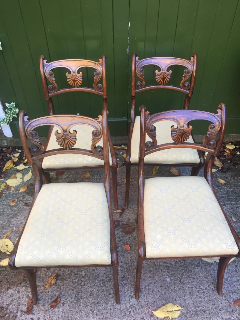 A set of four early nineteenth-century Regency Greek Revival side chairs with carved anthemion backrests and yellow upholstered seats. View VII