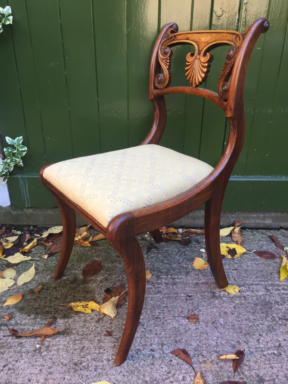 A set of four early nineteenth-century Regency Greek Revival side chairs with carved anthemion backrests and yellow upholstered seats. View IX