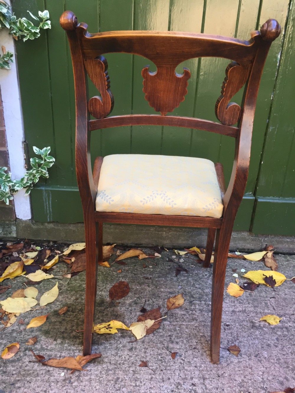A set of four early nineteenth-century Regency Greek Revival side chairs with carved anthemion backrests and yellow upholstered seats. View XI