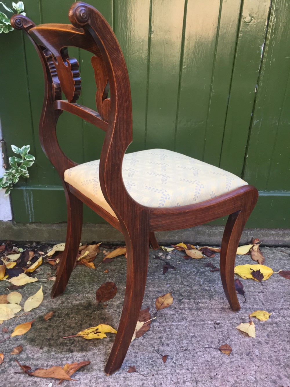 A set of four early nineteenth-century Regency Greek Revival side chairs with carved anthemion backrests and yellow upholstered seats. View XII