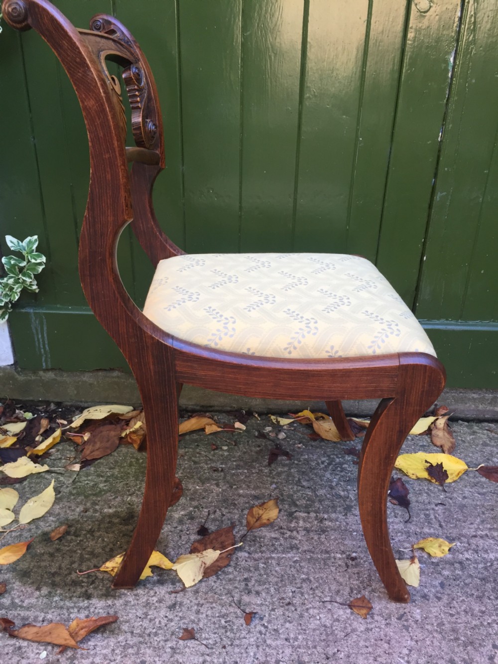 A set of four early nineteenth-century Regency Greek Revival side chairs with carved anthemion backrests and yellow upholstered seats. View XIII