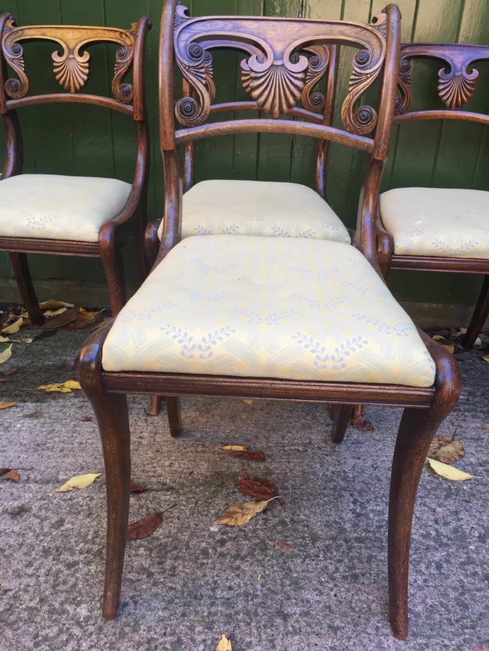 A set of four early nineteenth-century Regency Greek Revival side chairs with carved anthemion backrests and yellow upholstered seats. View XV