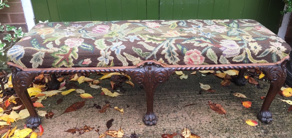 Late C19th George II period style carved mahogany stool or window-seat with needlework tapestry covered top.