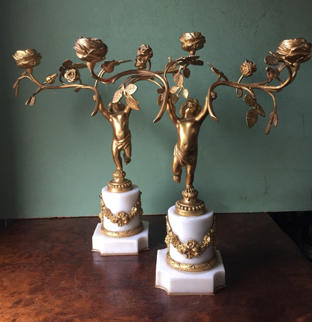 Smart quality pair of French late C19th ormolu bronze and white marble cherub candelabras.