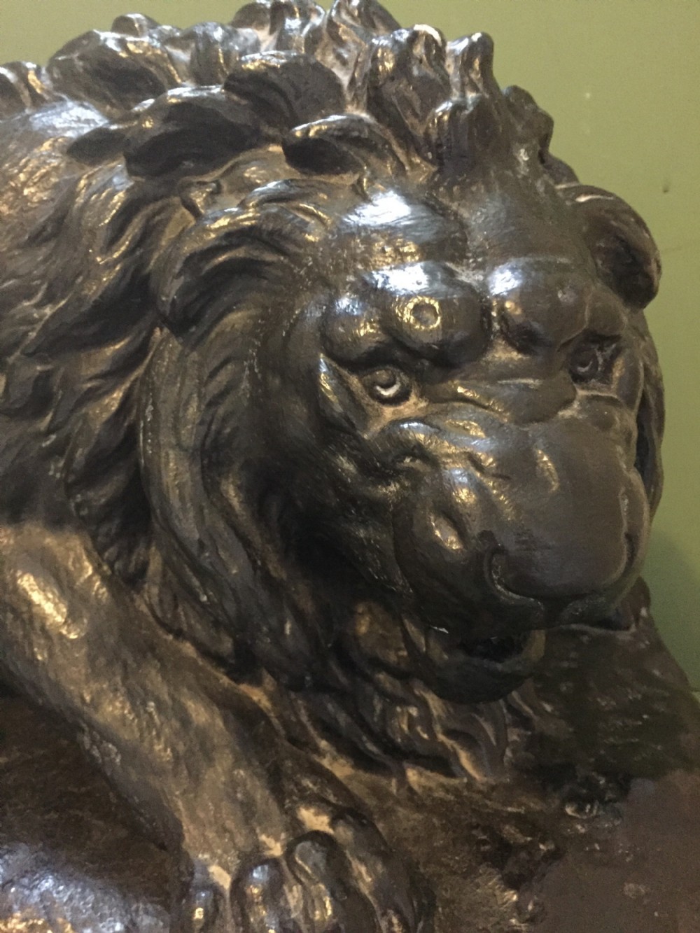 A nineteenth-century bronzed plaster sculpture depicting a prowling lion mounted on an octagonal base. View III