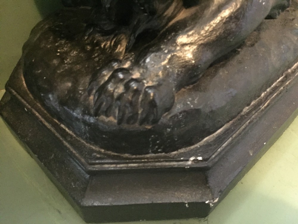 A nineteenth-century bronzed plaster sculpture depicting a prowling lion mounted on an octagonal base. View XI