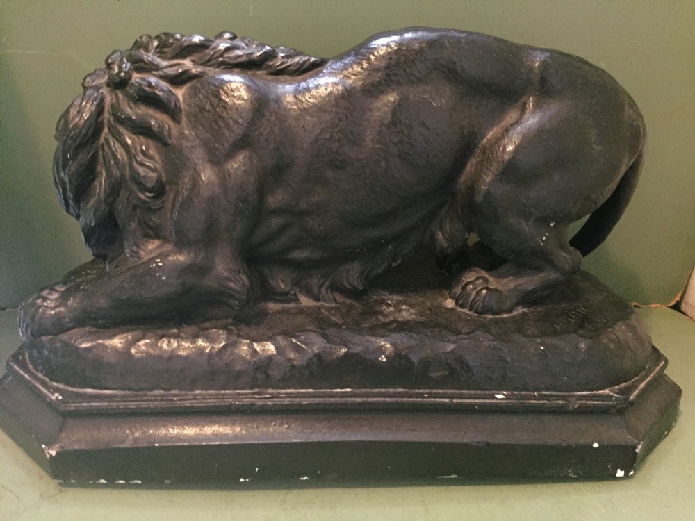 A nineteenth-century bronzed plaster sculpture depicting a prowling lion mounted on an octagonal base. View XII