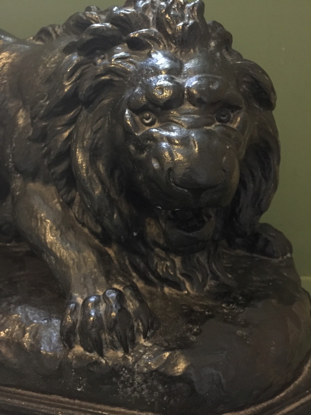 A nineteenth-century bronzed plaster sculpture depicting a prowling lion mounted on an octagonal base. View XV