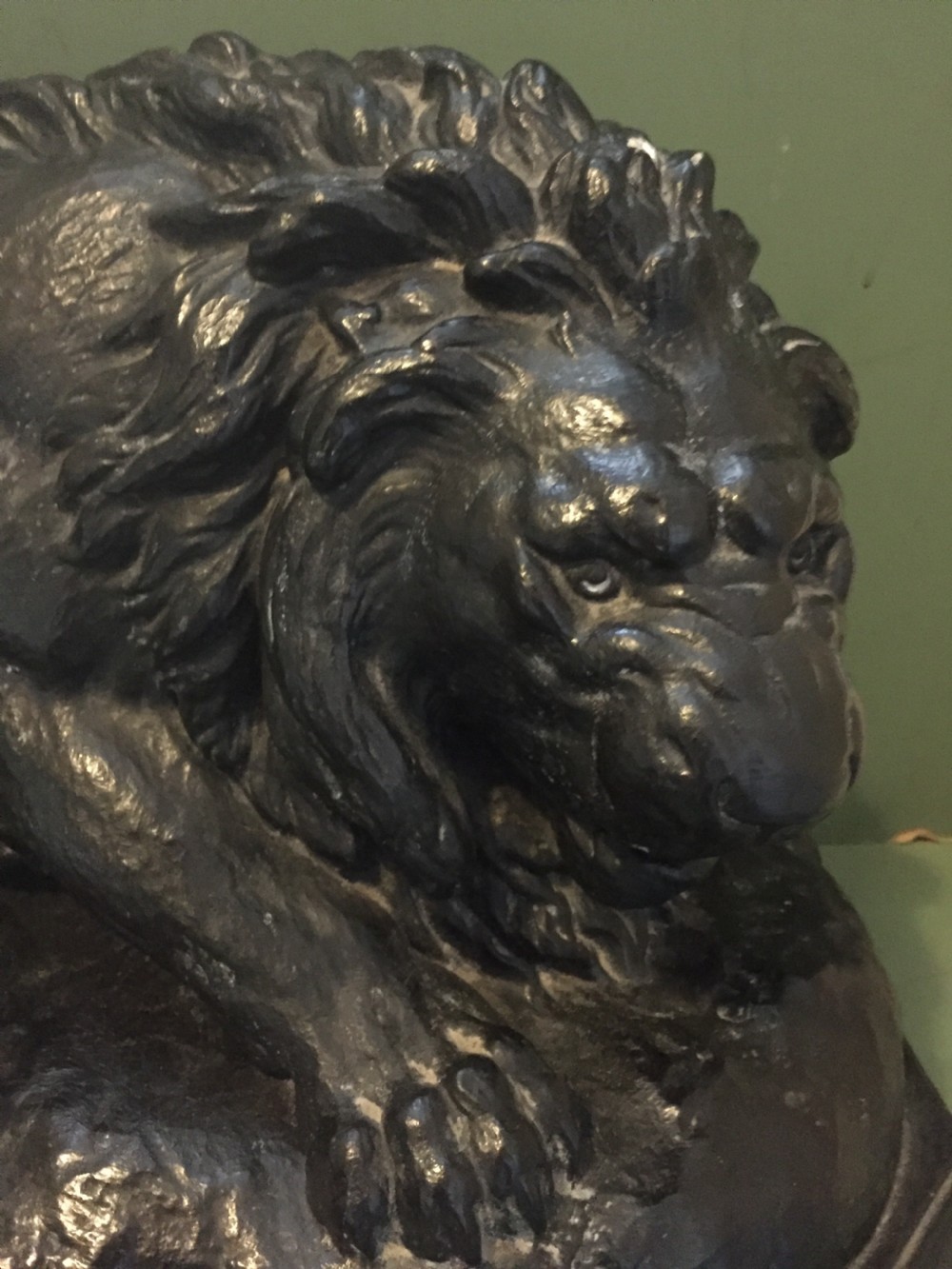 A nineteenth-century bronzed plaster sculpture depicting a prowling lion mounted on an octagonal base. View XXII