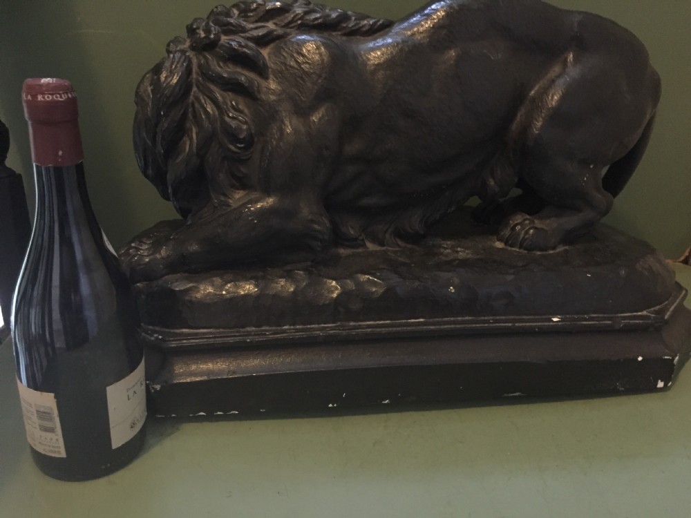 A nineteenth-century bronzed plaster sculpture depicting a prowling lion mounted on an octagonal base. View XXV
