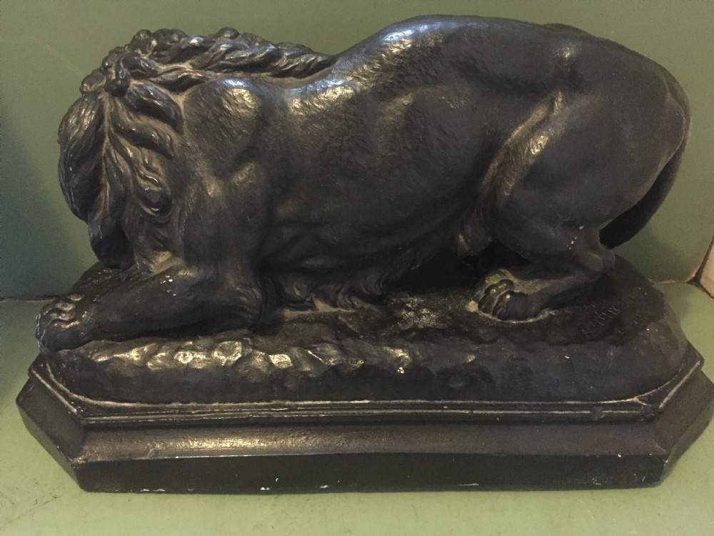 A nineteenth-century bronzed plaster sculpture depicting a prowling lion mounted on an octagonal base. View VIII