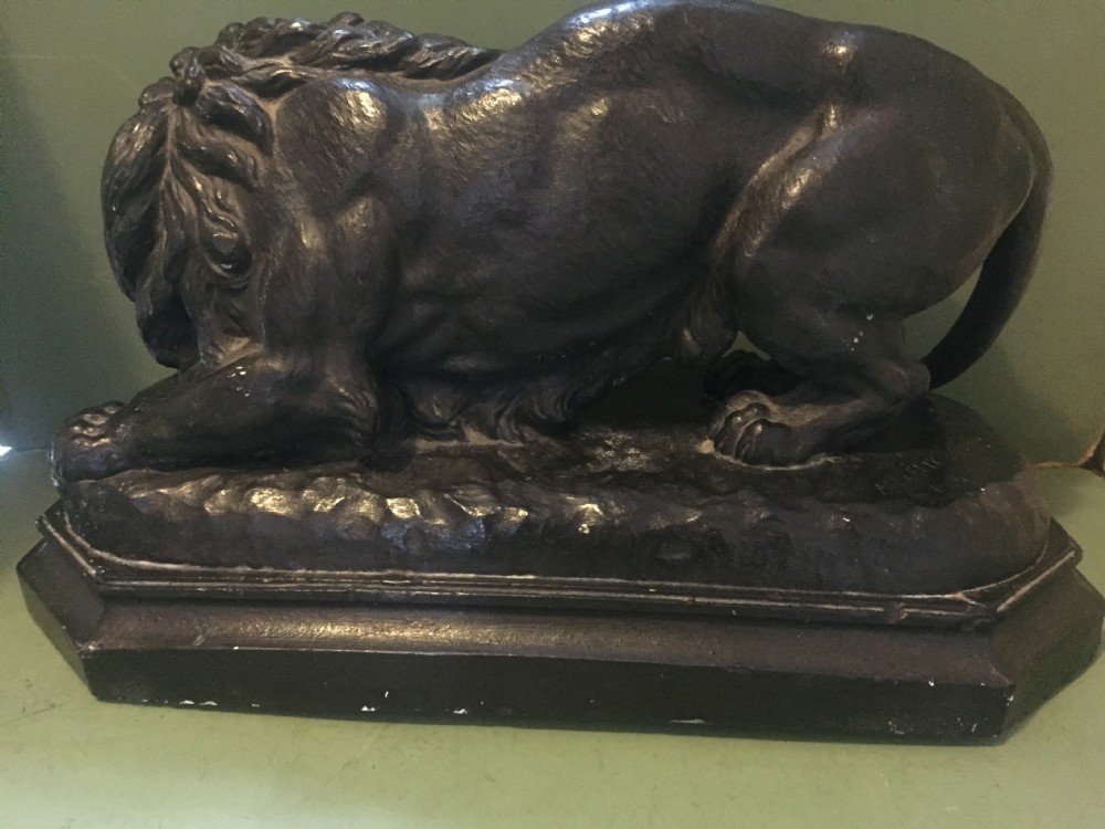 A nineteenth-century bronzed plaster sculpture depicting a prowling lion mounted on an octagonal base. View XIV