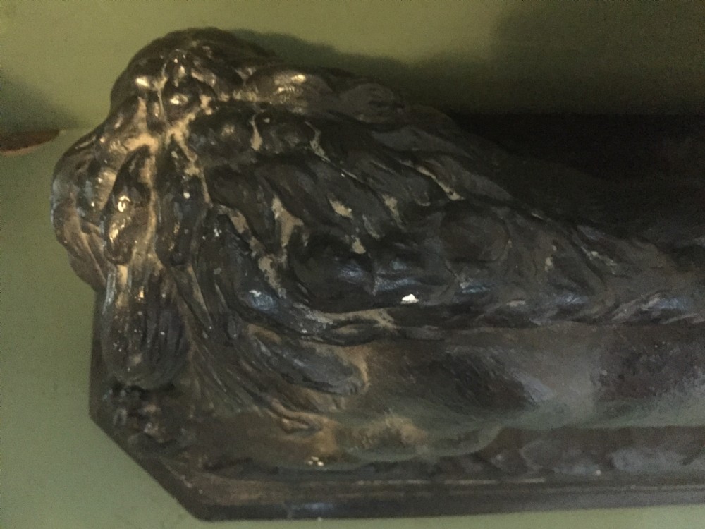 A nineteenth-century bronzed plaster sculpture depicting a prowling lion mounted on an octagonal base. View XVIII