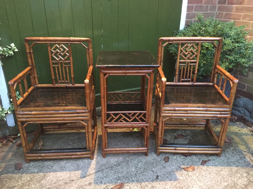 Decorative pair of early C20th Chinese polished bamboo and lacquer armchairs and table in the C18th manner  . View II