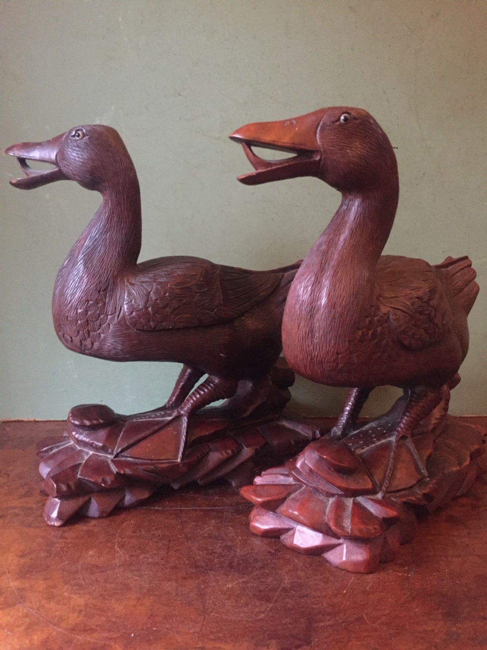 A pair of late nineteenth-century Chinese hardwood carved ducks with open beaks resting on sculpted bases. View II
